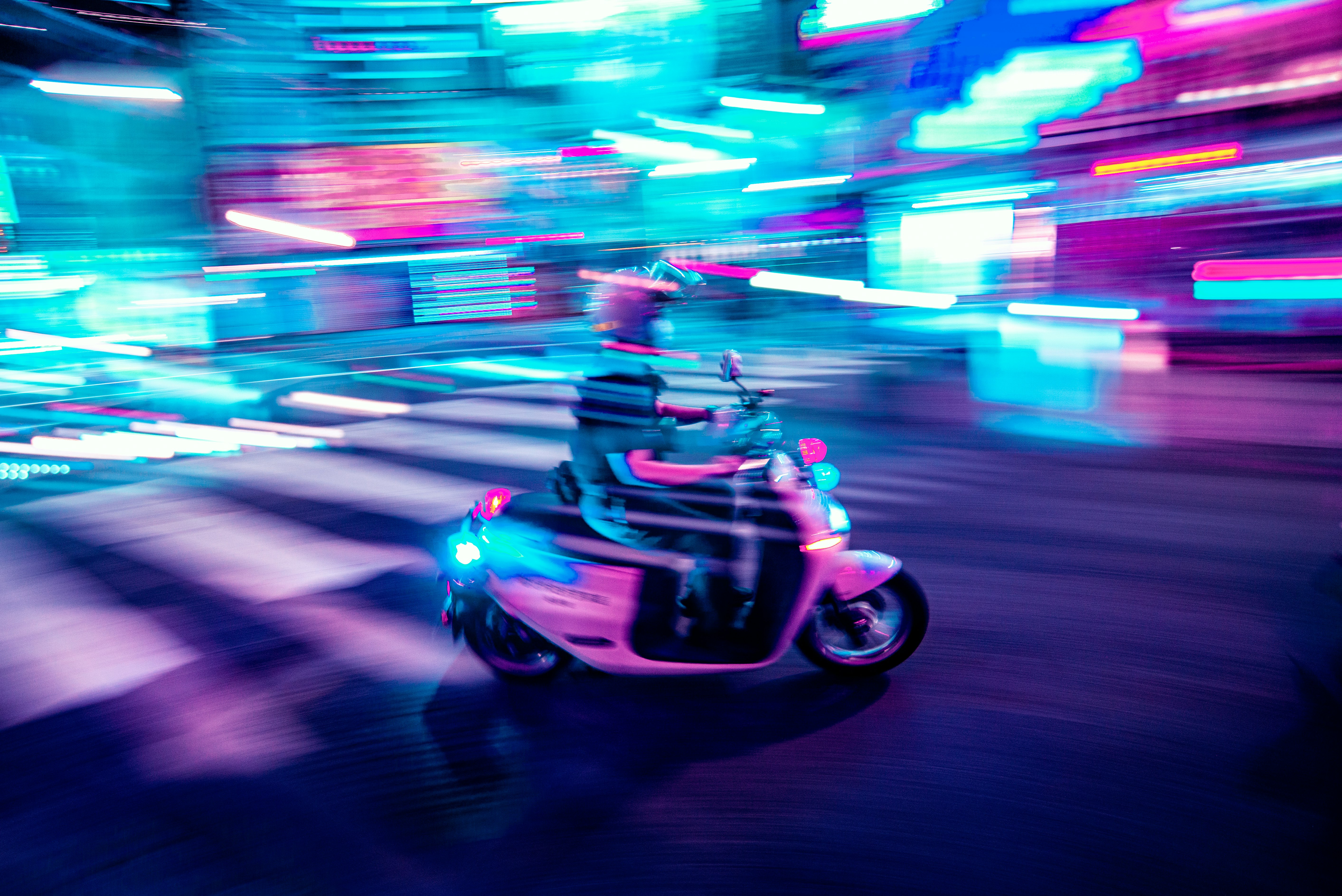 man riding red and black motorcycle on road during night time